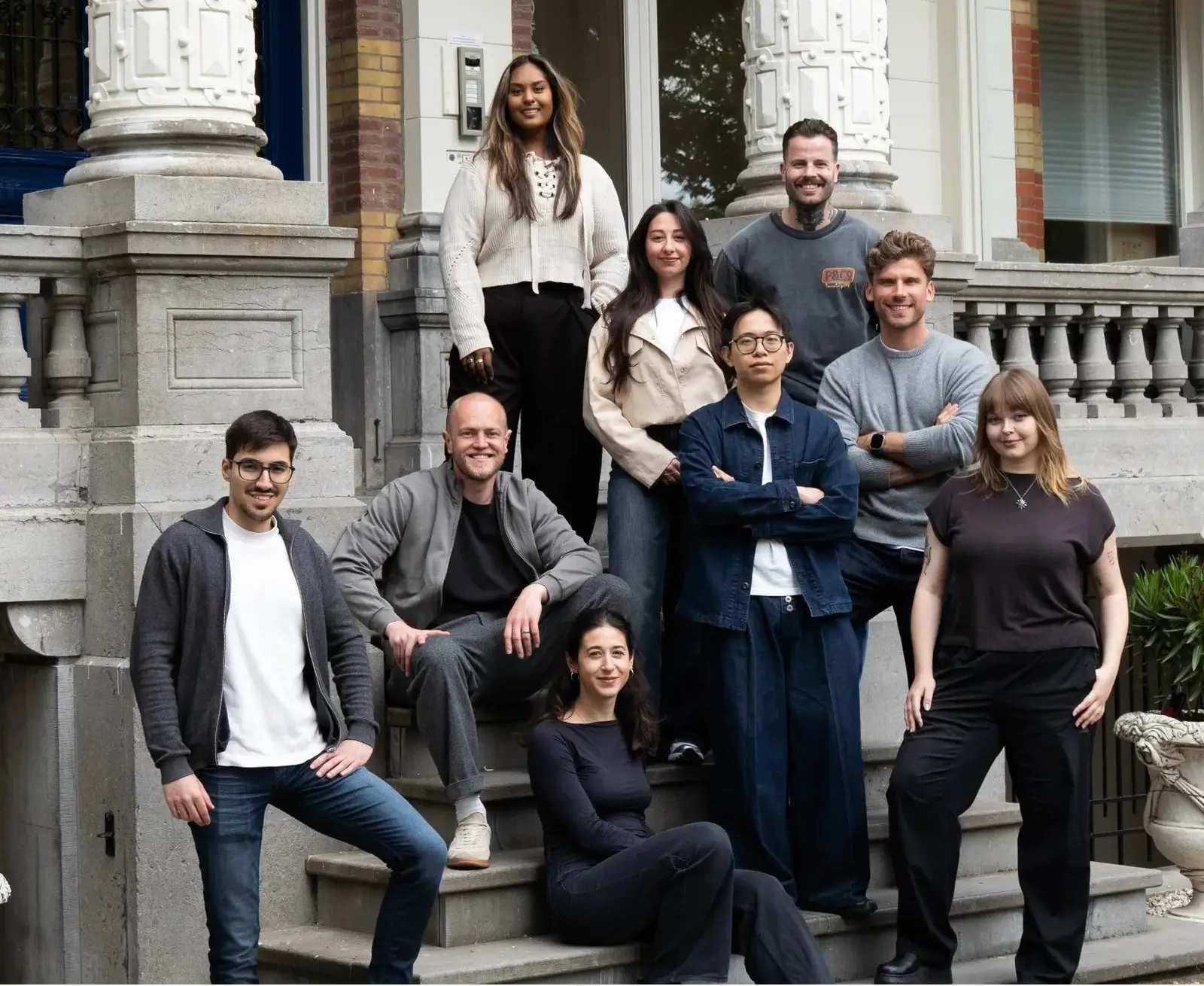 Ascent founders and employees posing on steps in front of a classical office building